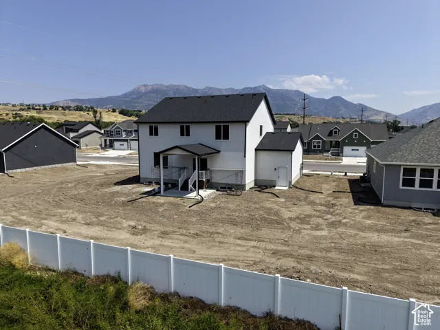 Newly constructed residence with a dark shingle roof and a white exterior finish