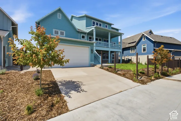 Multi-level exterior with a two-car garage and a second-story balcony