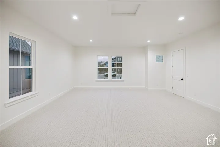 600 sq ft bonus room over the garage! Neutral interior featuring wall-to-wall carpeting, recessed ceiling lighting, two double-hung windows, and a single-panel interior door