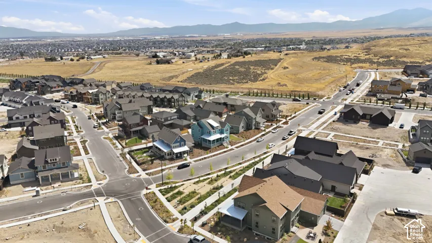 Residential development with varied architectural styles, paved roadways, and landscaped common areas