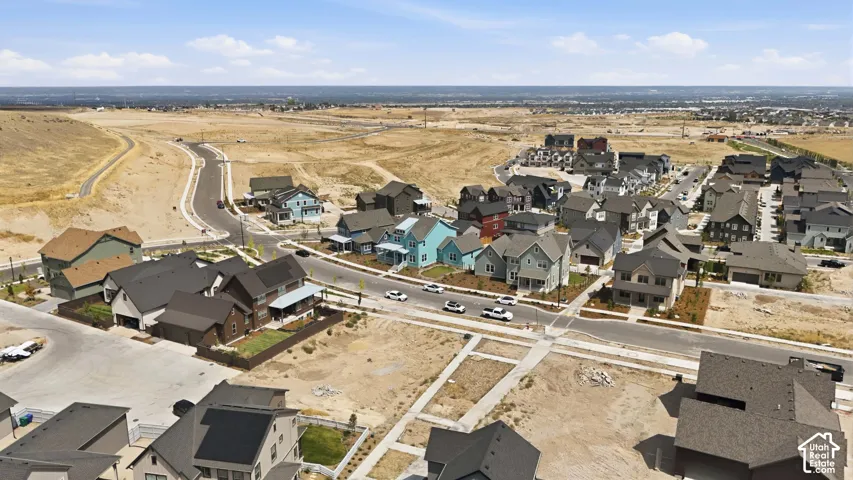Developing neighborhood featuring diverse architectural styles and paved roadways