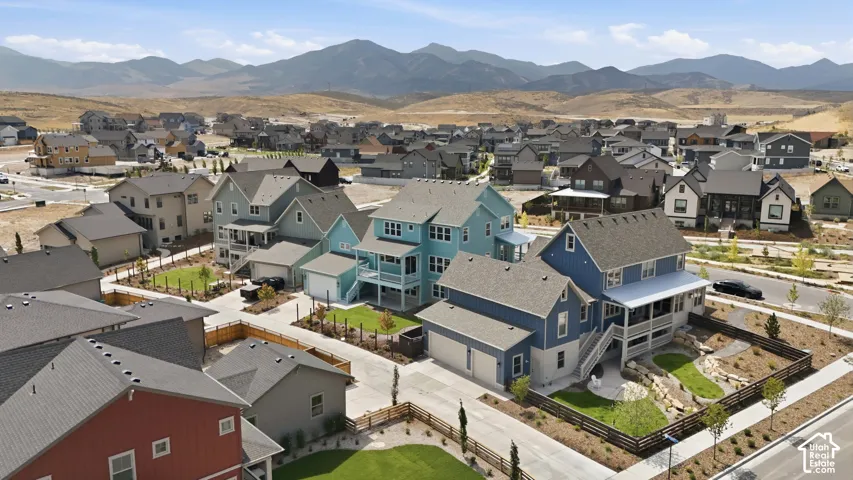 Residential neighborhood featuring contemporary homes, paved streets, and mountainous terrain
