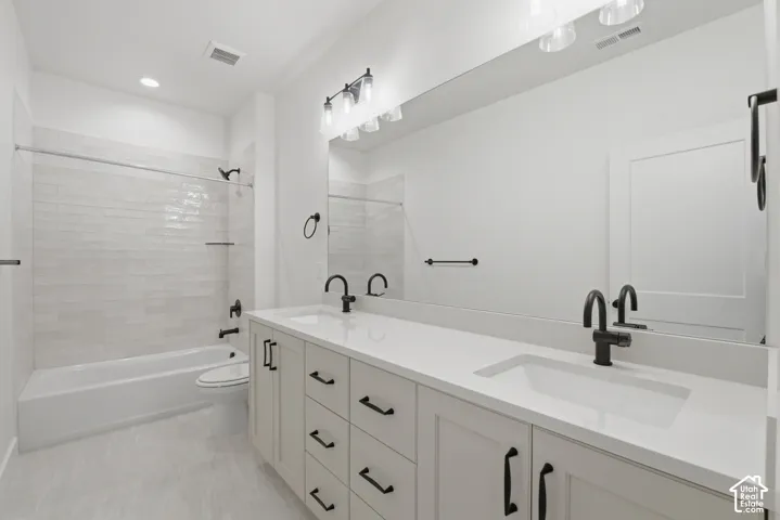 Dual vanity with light cabinetry, white countertop, and matte black fixtures
