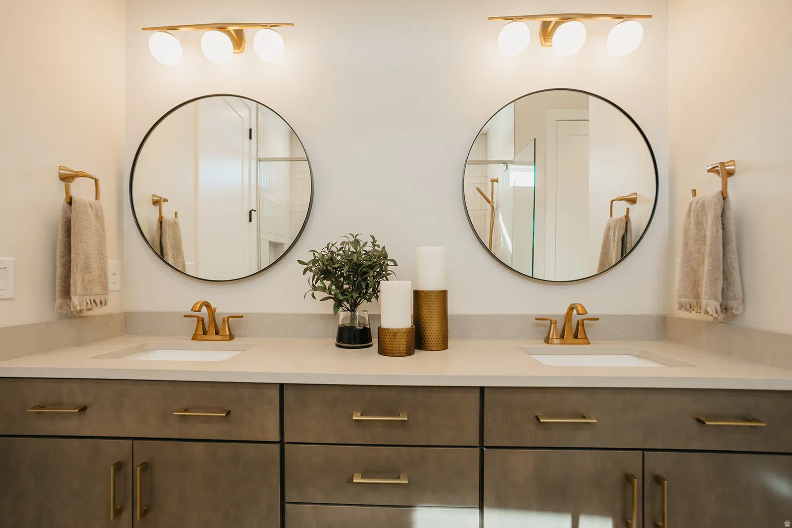 Double vanity with integrated sinks and gold-finish hardware