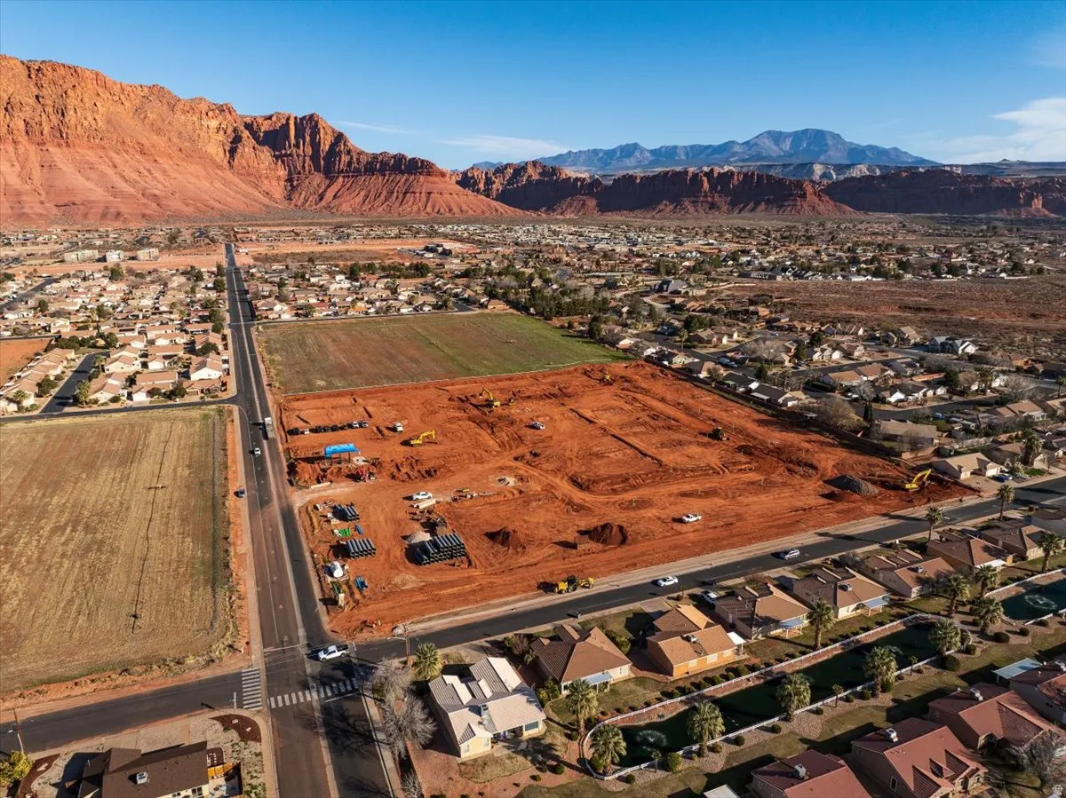 Expansive land parcel with surrounding residential areas and mountain backdrop