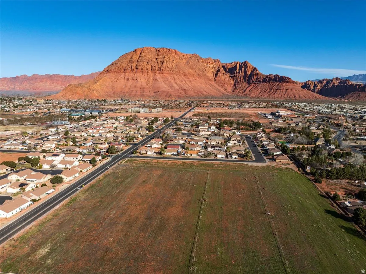 Expansive agricultural land parcel with established residential neighborhoods nearby