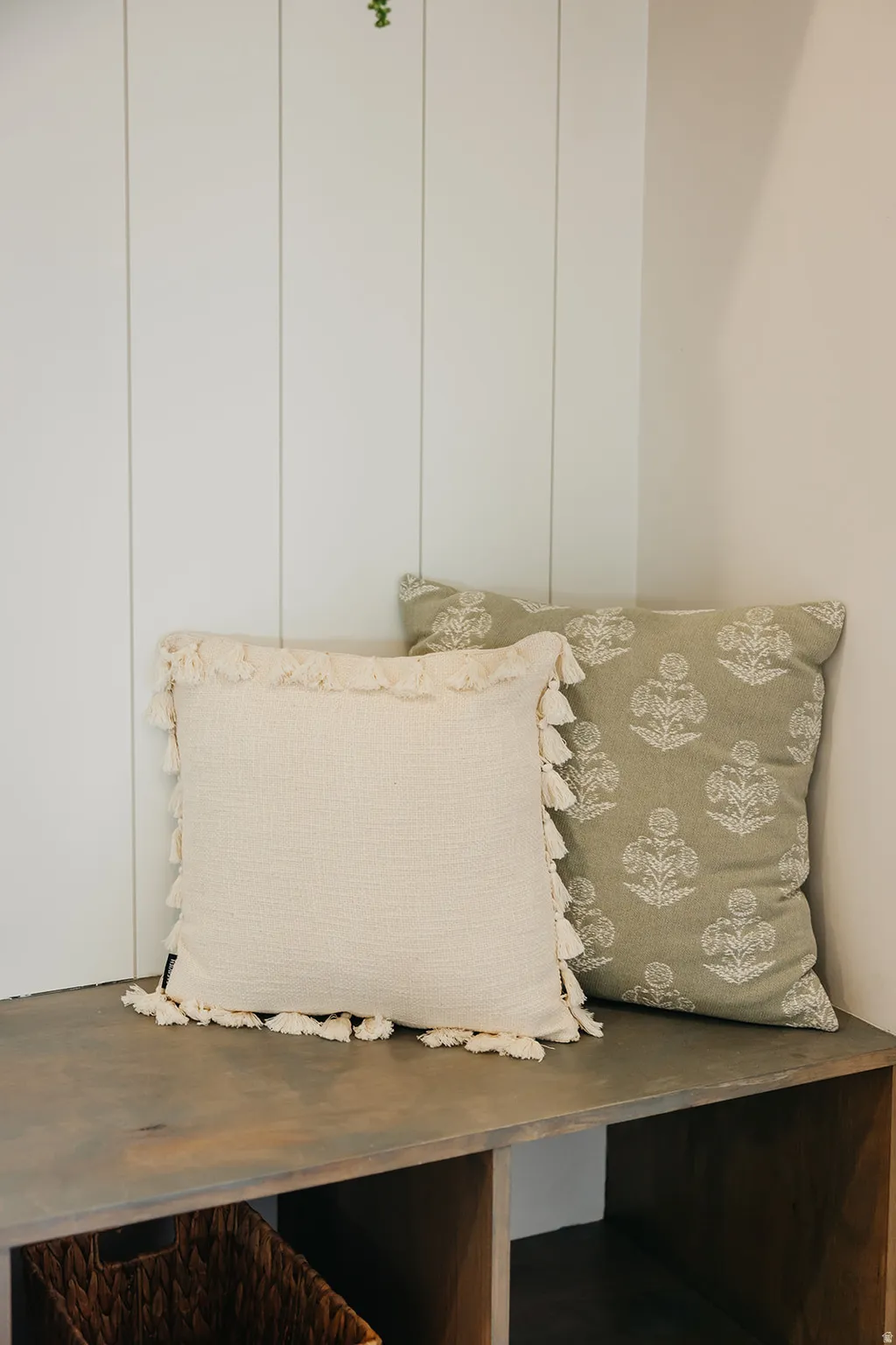Built-in wood-finish bench with open shelving, complemented by a vertical paneled wall