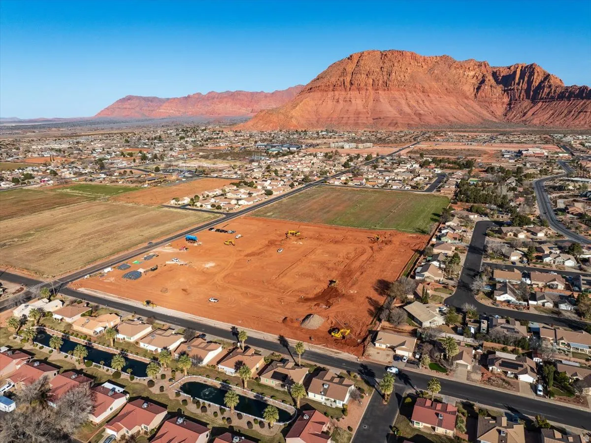 Expansive land parcel with surrounding residential areas, bordered by a paved road