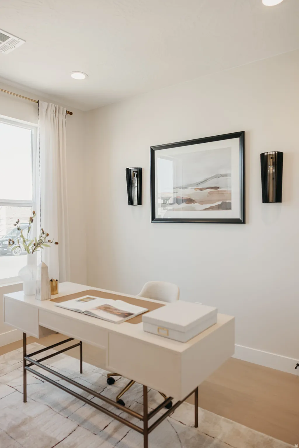Recessed ceiling lighting, a window with curtain rod, and light-toned walls create a bright interior