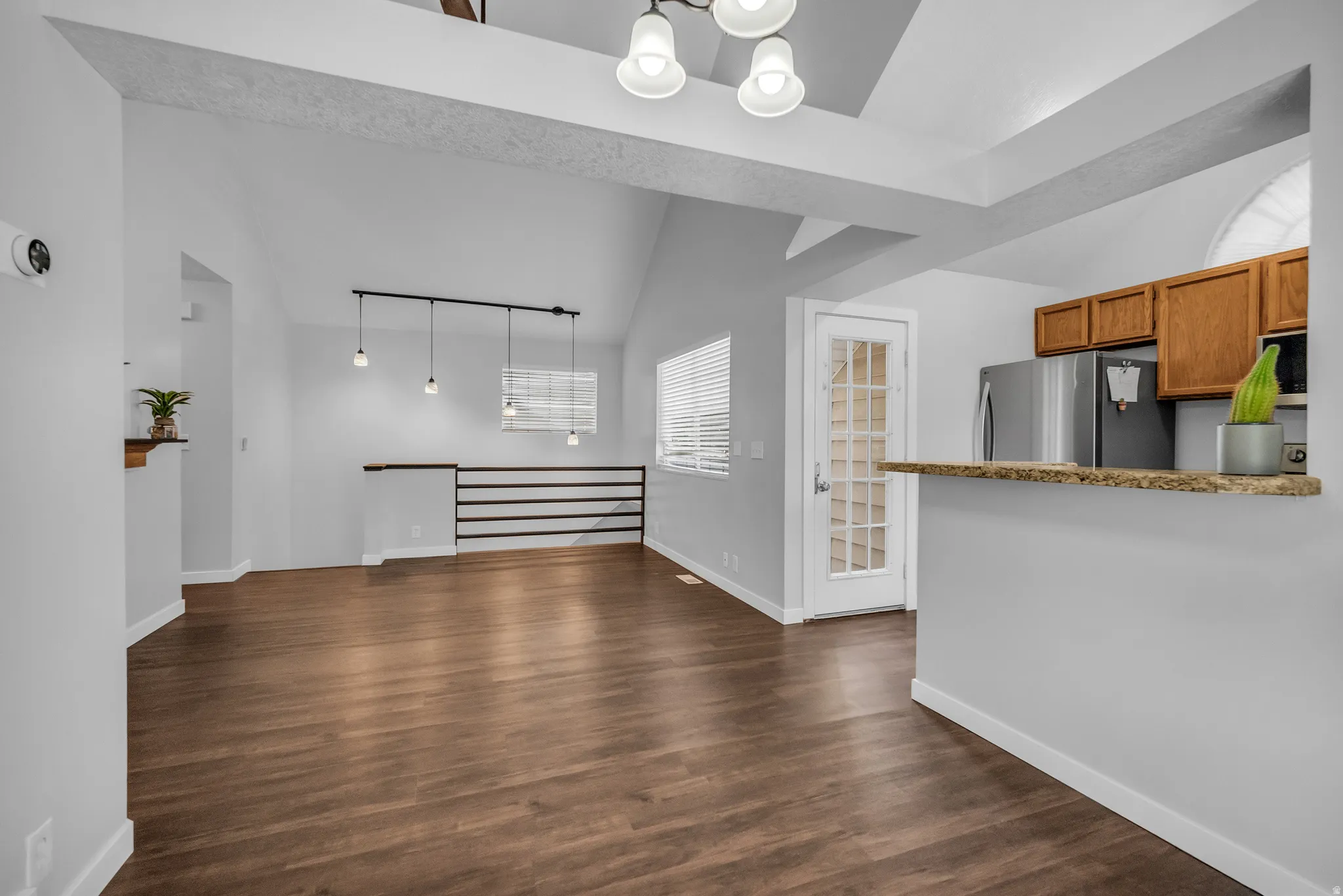 Vaulted ceiling with decorative beams and recessed lighting