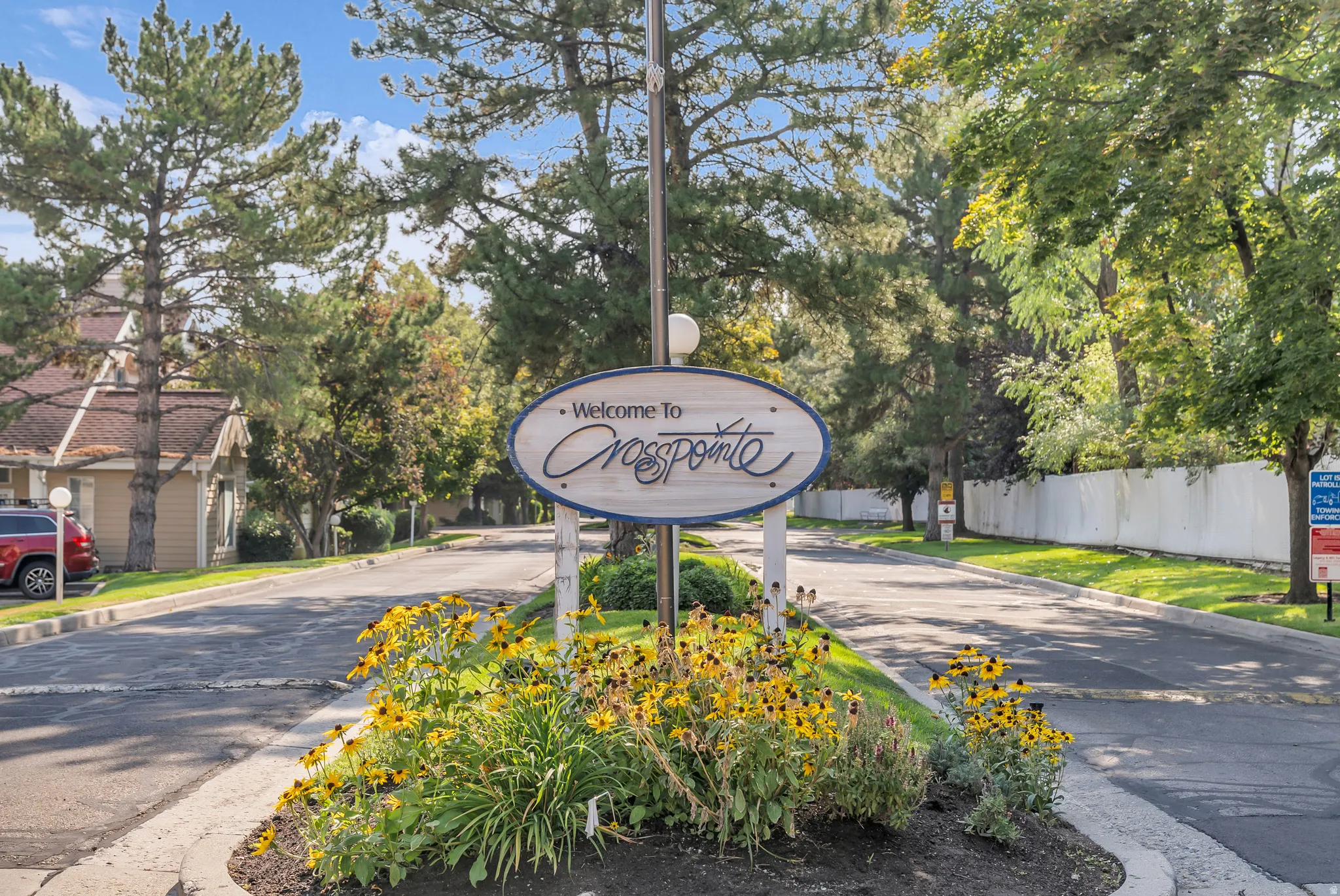 Entryway signage featuring "Welcome To Crosspointe" with decorative landscaping