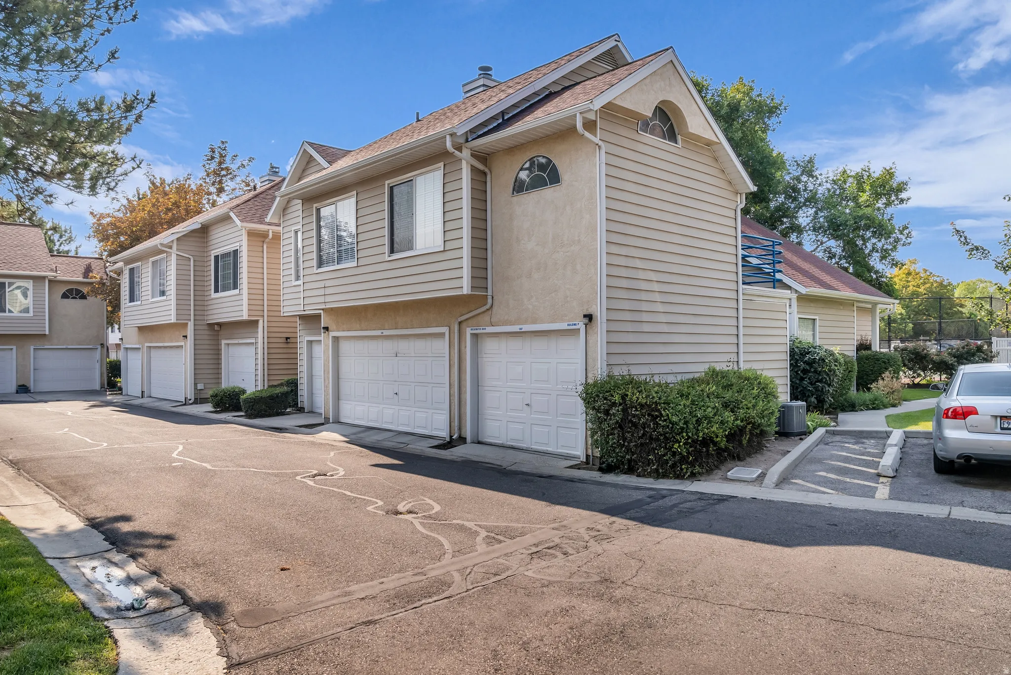 Exterior featuring horizontal siding, stucco finishes, and multiple garage doors