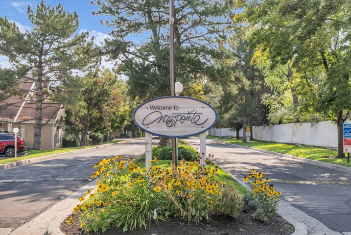 Entryway signage featuring "Welcome To Crosspointe" with decorative landscaping