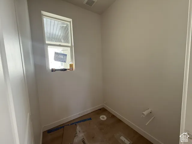 Single window, light-colored walls, white trim, wood-finish subfloor