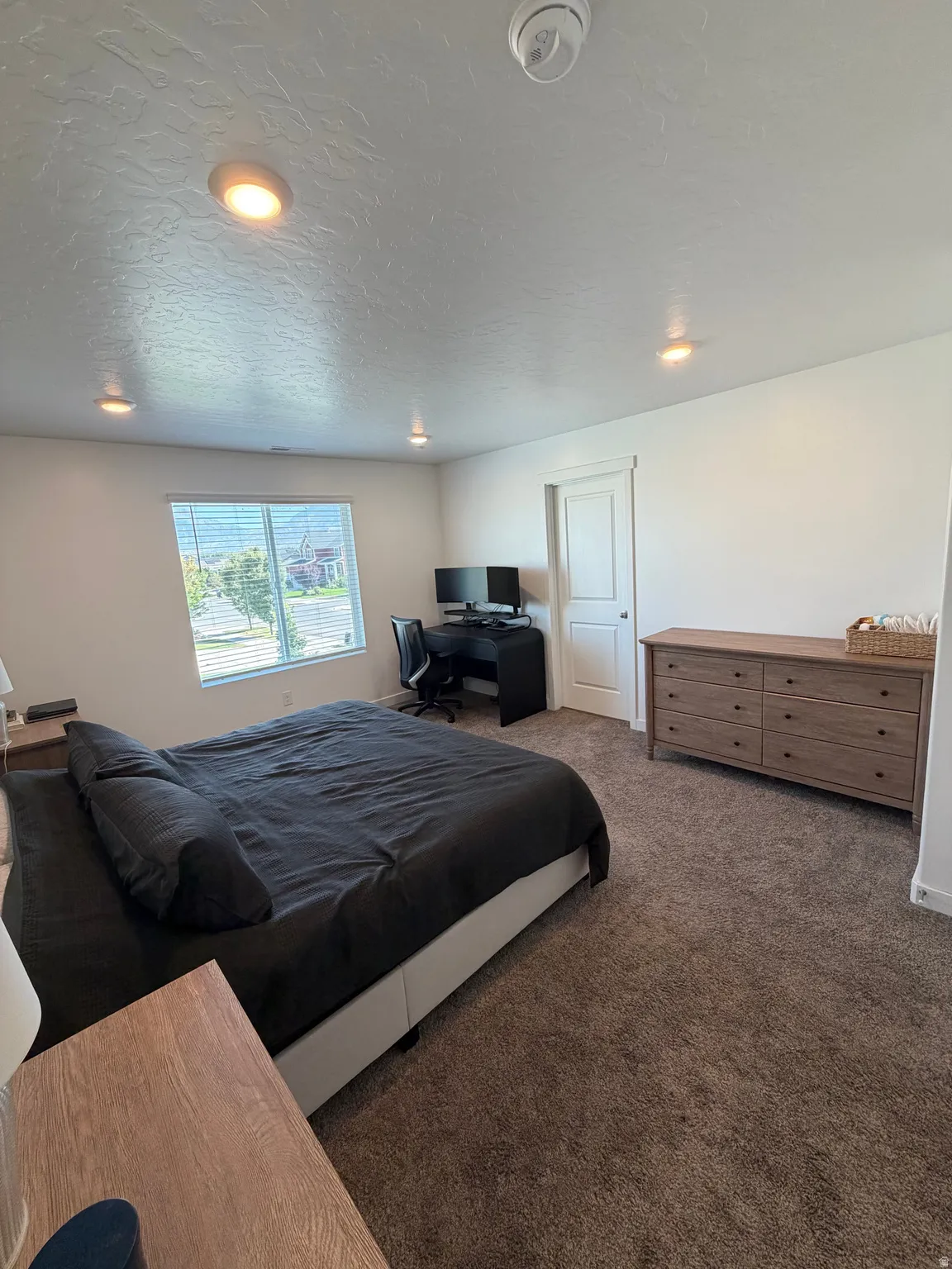 Recessed lighting, wall-to-wall carpeting, and a window with blinds