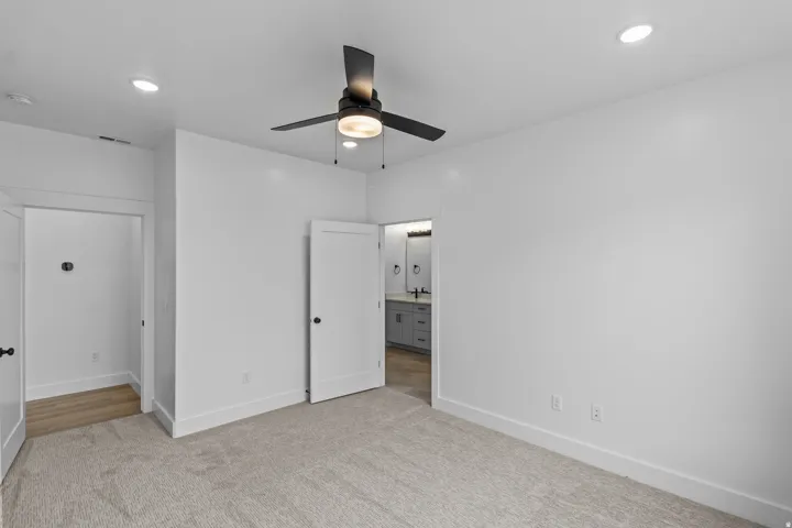 Recessed lighting, ceiling fan with integrated light, light-toned carpet flooring, white walls, and white trim