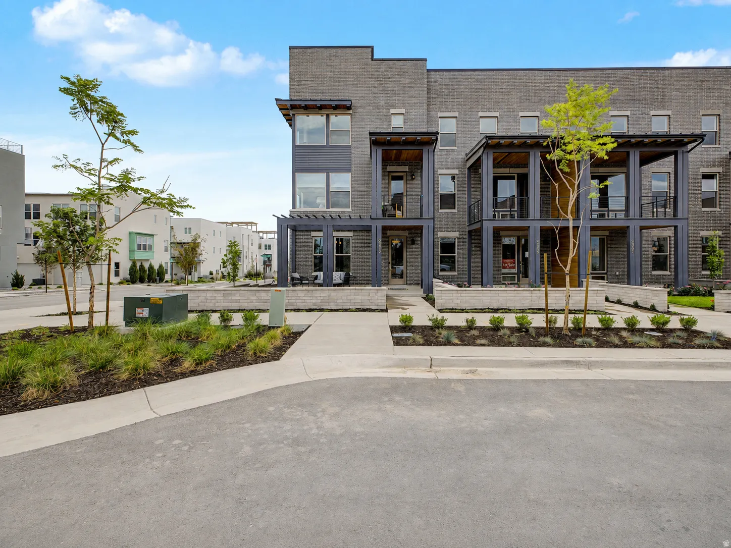 Contemporary multi-story exterior with gray brick and dark-framed windows
