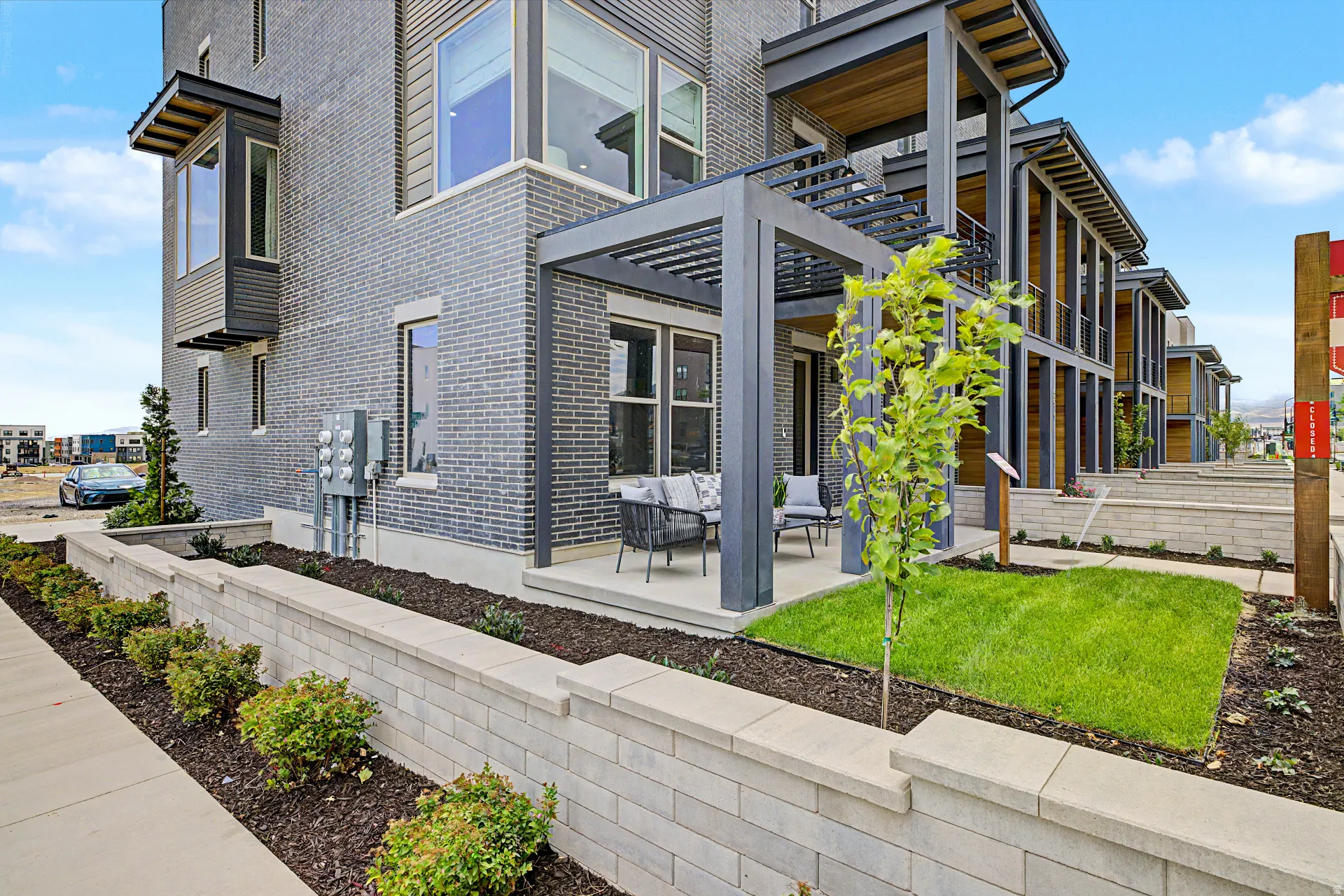 Contemporary exterior featuring gray brick and dark siding accents