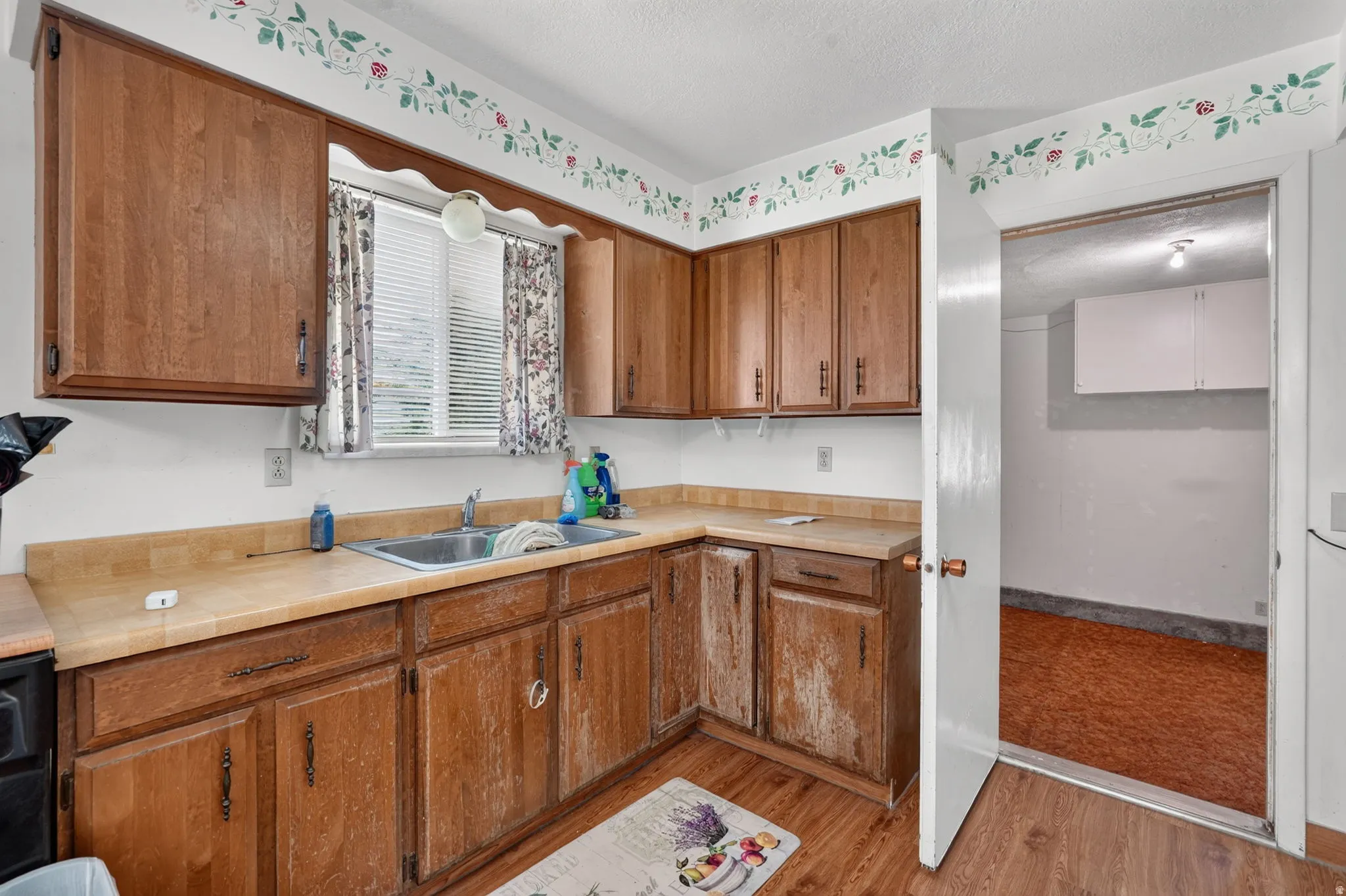 Kitchen featuring wood-finish cabinetry, a stainless steel sink, and wood-finish countertops