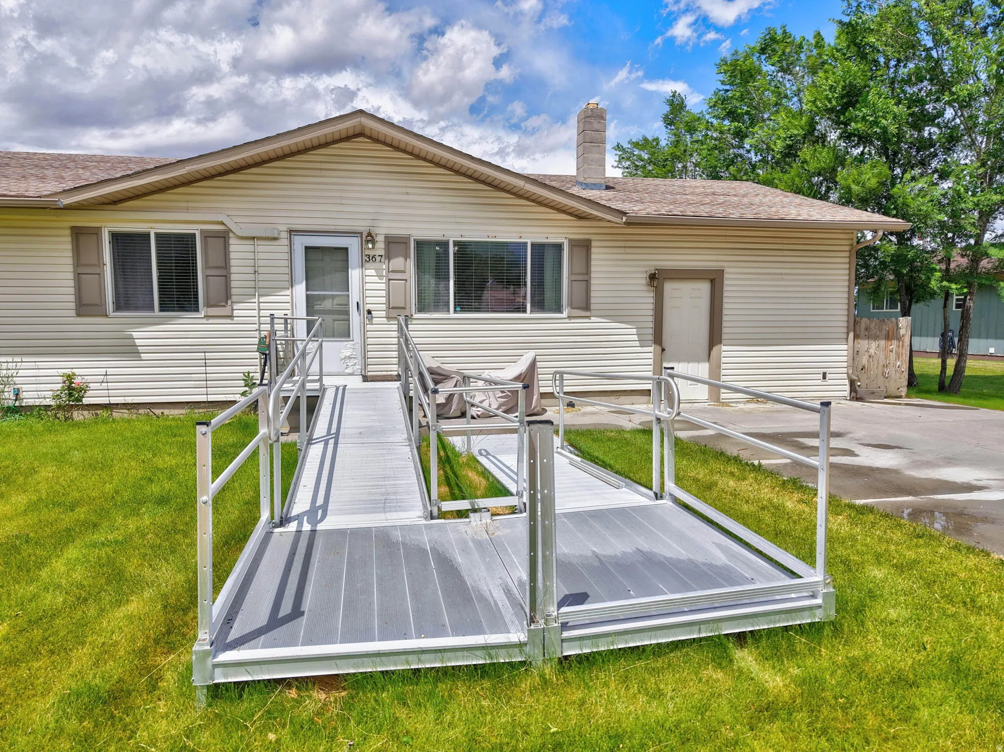 Front entry with a composite ramp and aluminum railings