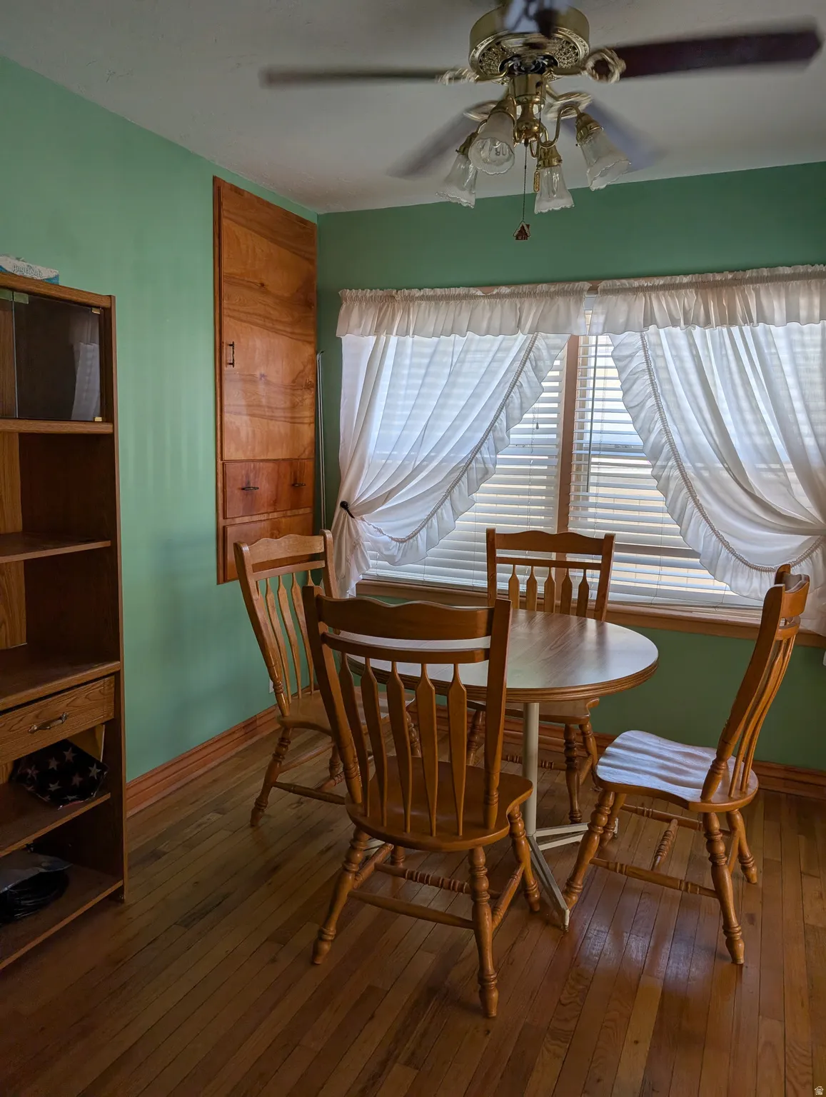 Wood-finish flooring with a ceiling fan light fixture