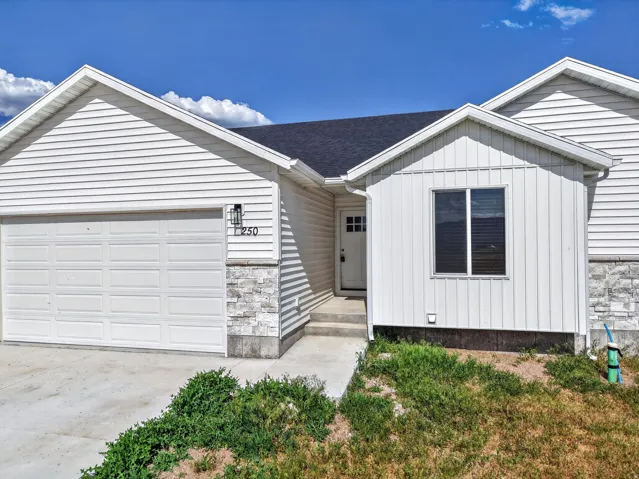 White siding exterior with a dark asphalt shingle roof