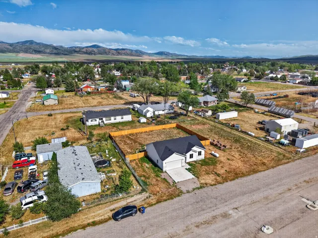 Single-story residence with an attached two-car garage, concrete driveway, and a fenced yard