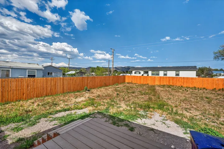 Expansive backyard featuring a new wood fence and a composite deck with steps