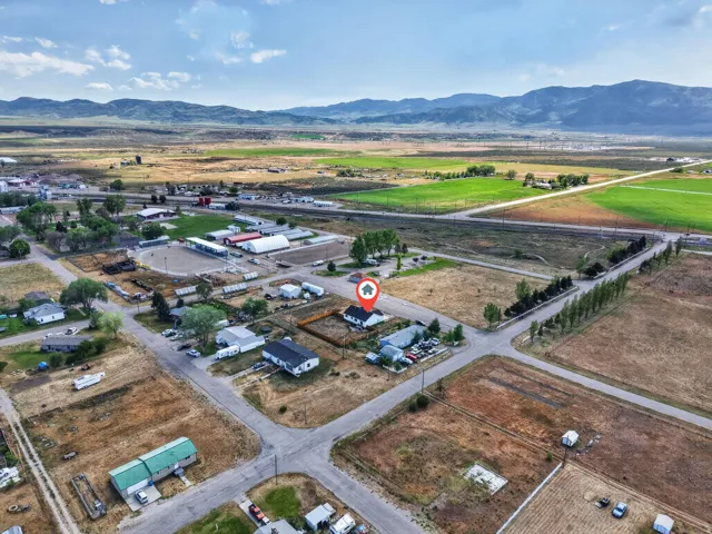 Expansive rural landscape featuring distant mountains and agricultural fields