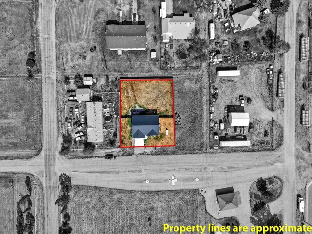 Single-family residence with a dark-pitched roof, located on a lot with undeveloped land