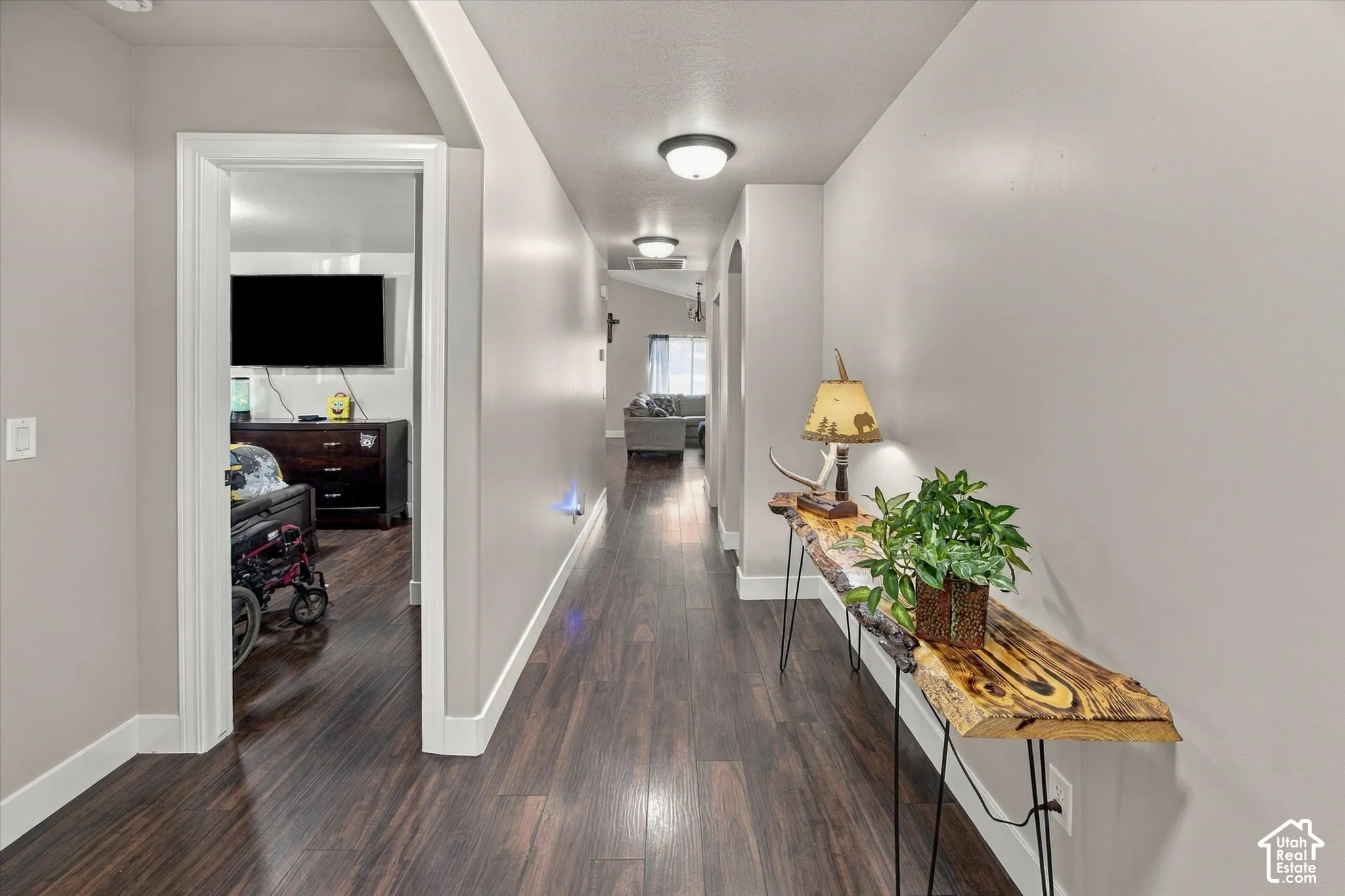 Wood-finish flooring throughout, complemented by light-toned walls and recessed lighting fixtures