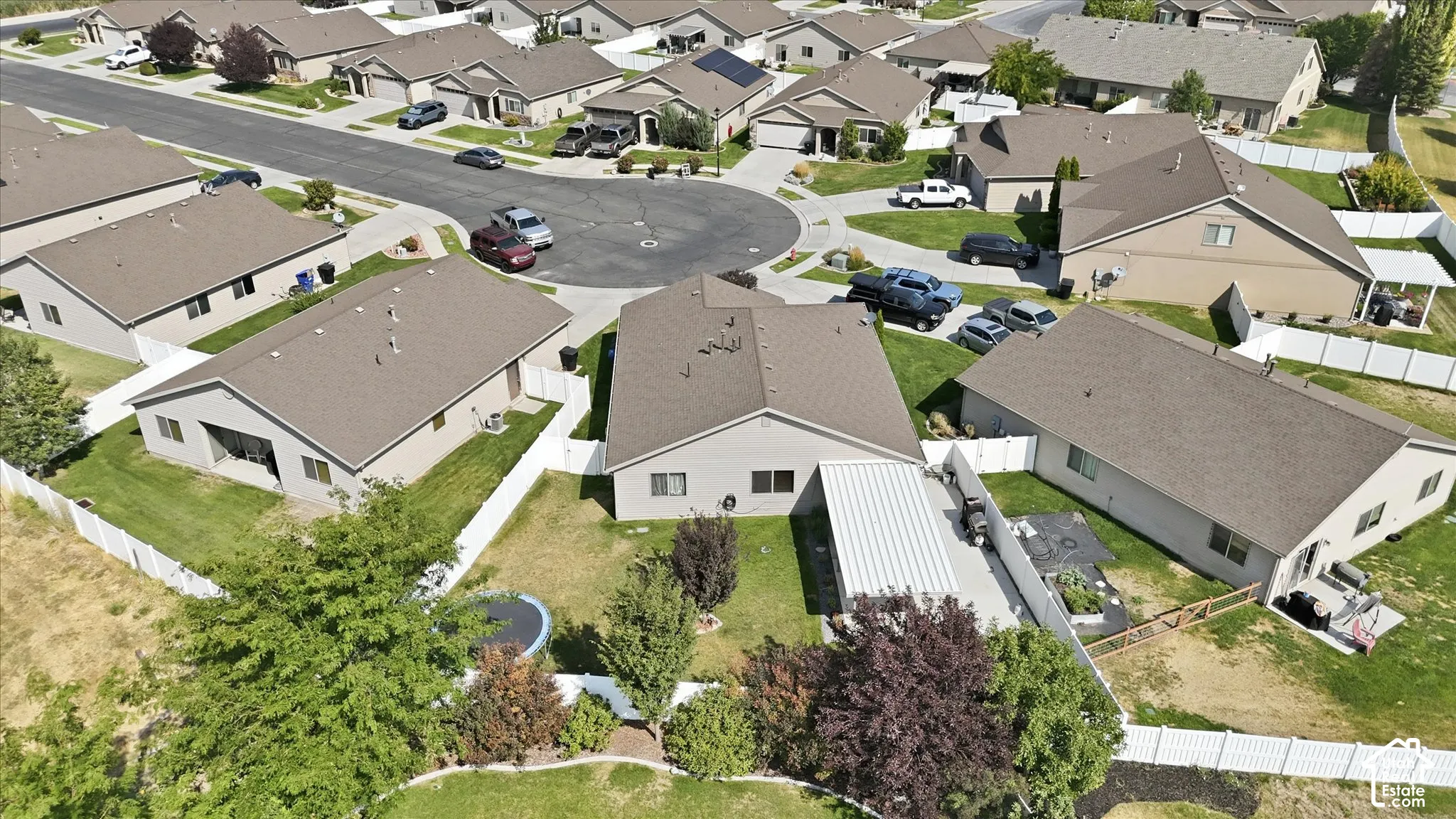 Single-story residence with a covered patio, fenced backyard, and a paved driveway