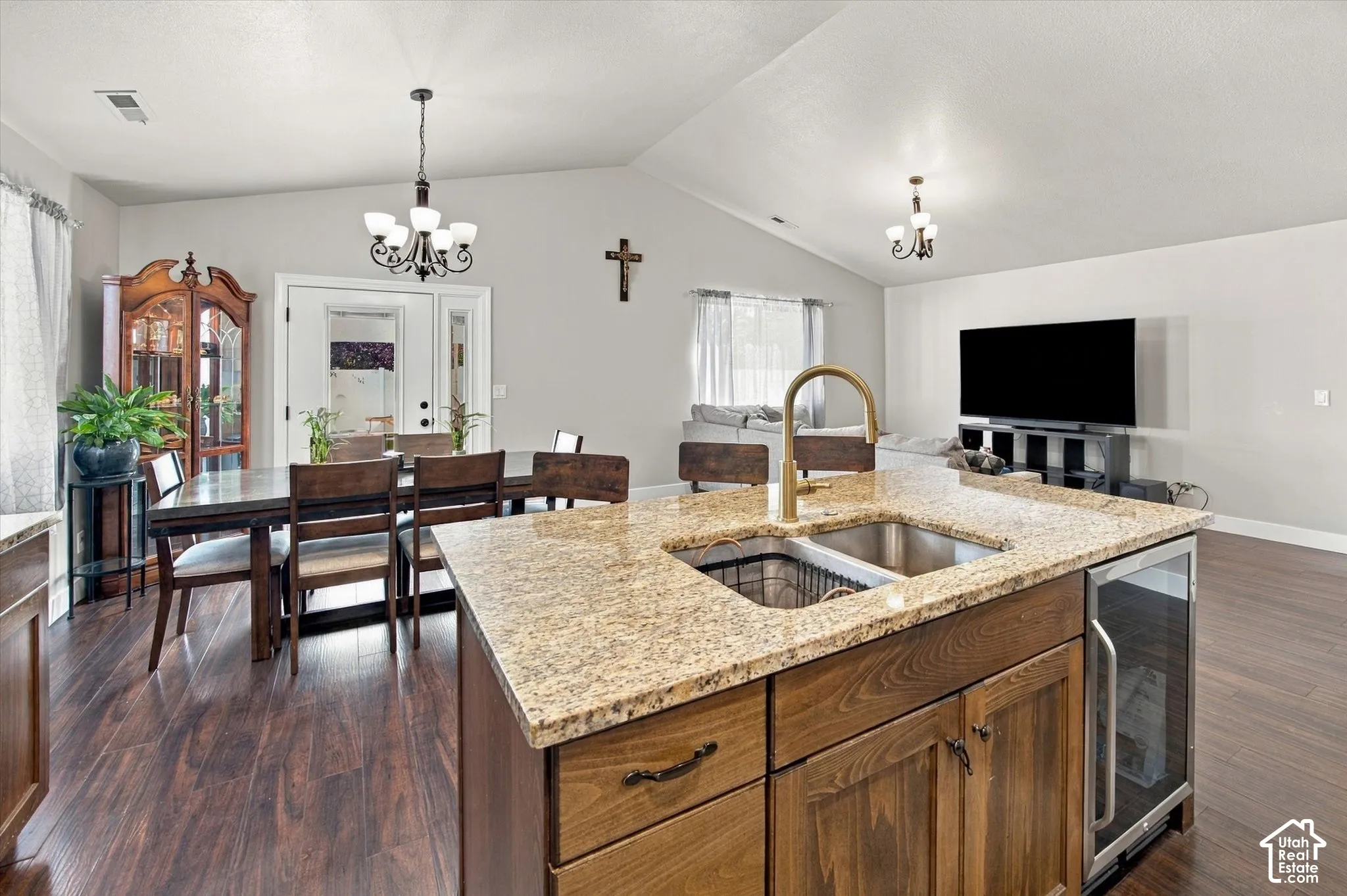 Kitchen island featuring a stainless-steel undermount sink, gooseneck faucet, and integrated beverage refrigerator