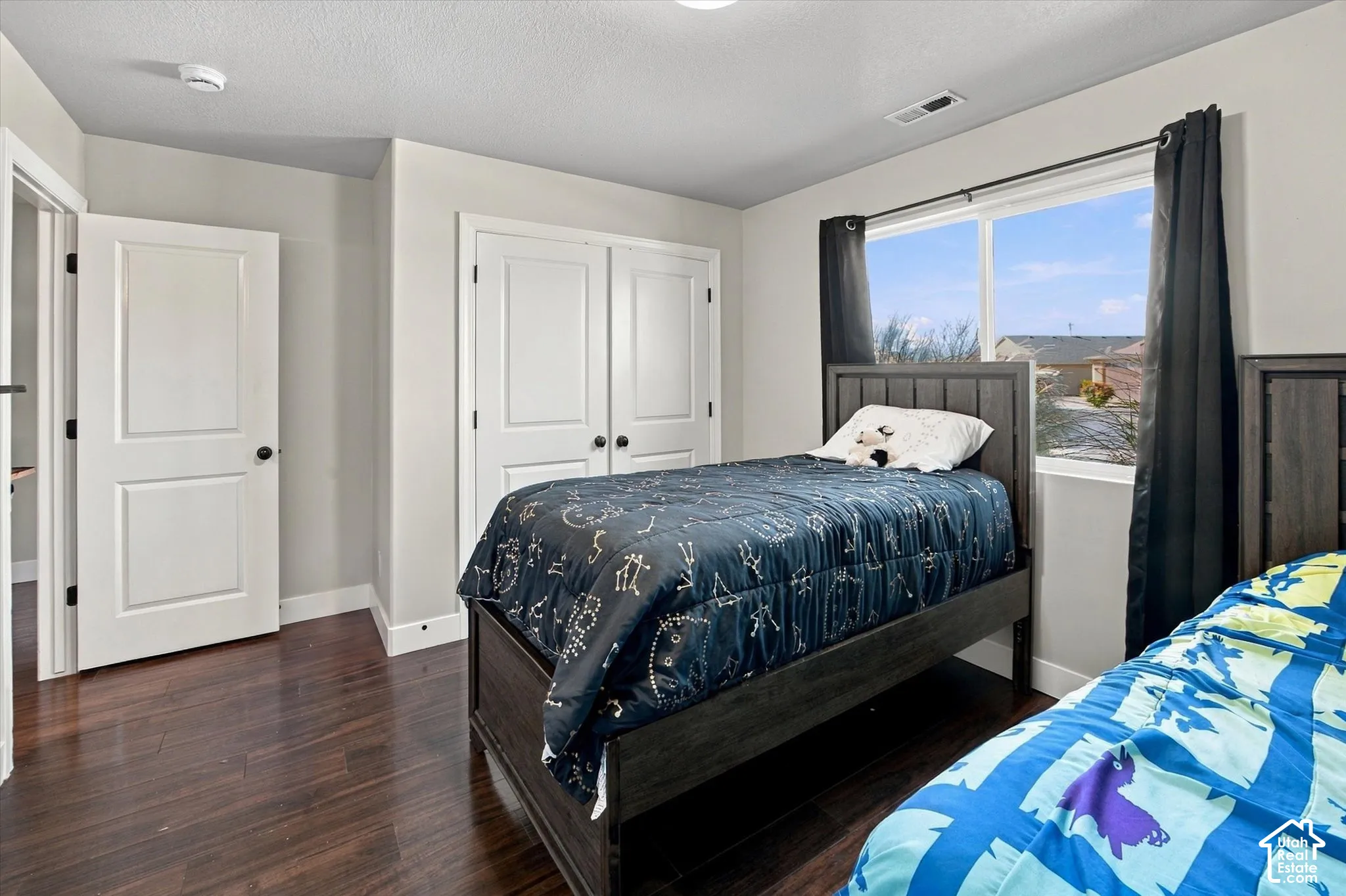 Hardwood-finish flooring, white paneled doors, and a double-pane window