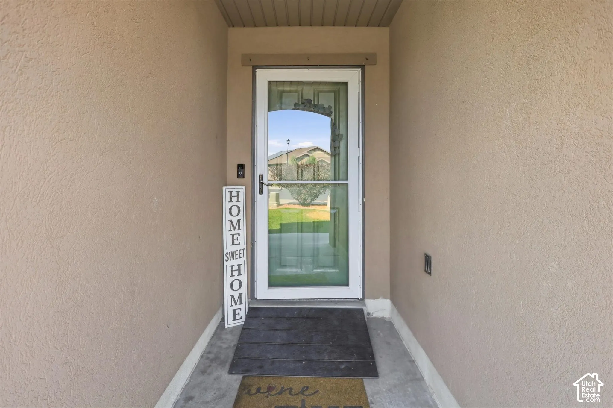 Stucco exterior with a full glass storm door
