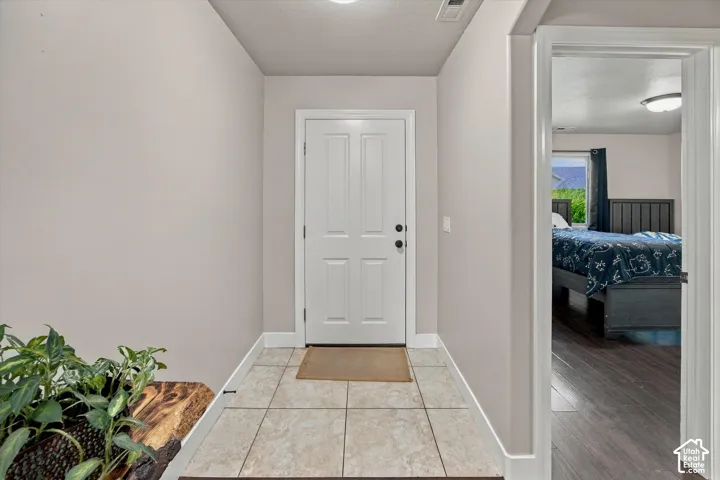 Tiled entry flooring with a paneled door