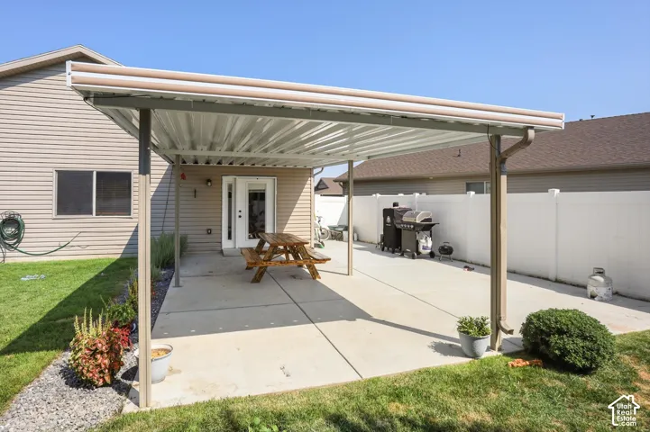 Expansive concrete patio with a full-length covered awning