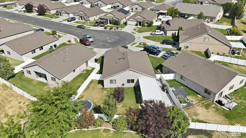 Single-story residence with a covered patio, fenced backyard, and a paved driveway