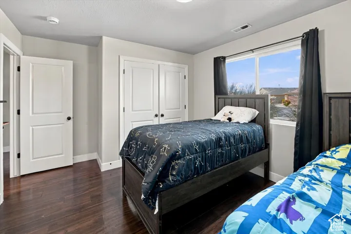 Hardwood-finish flooring, white paneled doors, and a double-pane window