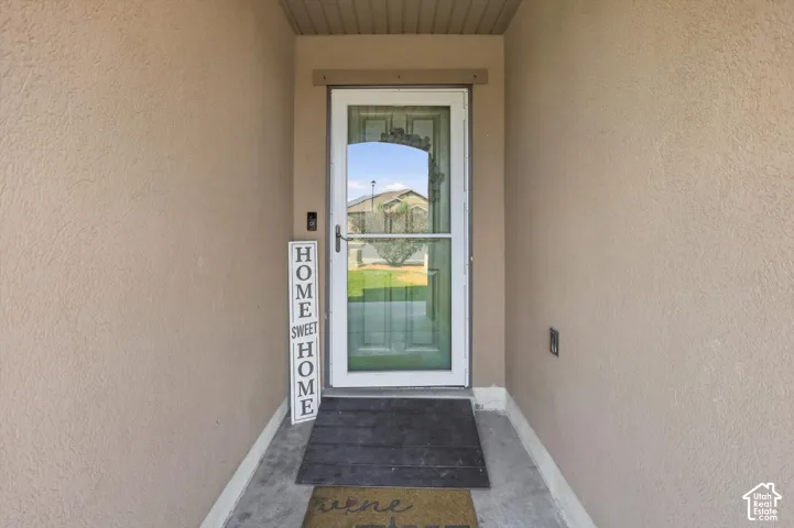Stucco exterior with a full glass storm door