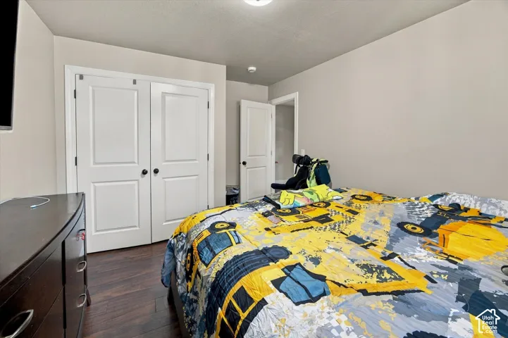 Wood-finish flooring, light-toned walls, and a ceiling light fixture