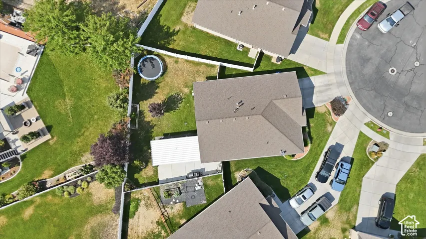 Property features a cul-de-sac location, paved driveway, expansive green lawn, and mature trees