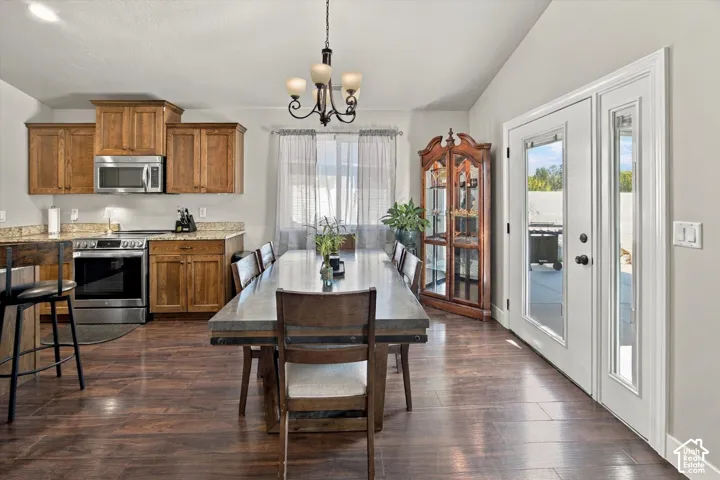 Kitchen and dining area featuring wood-finish flooring, recessed lighting, and a chandelier