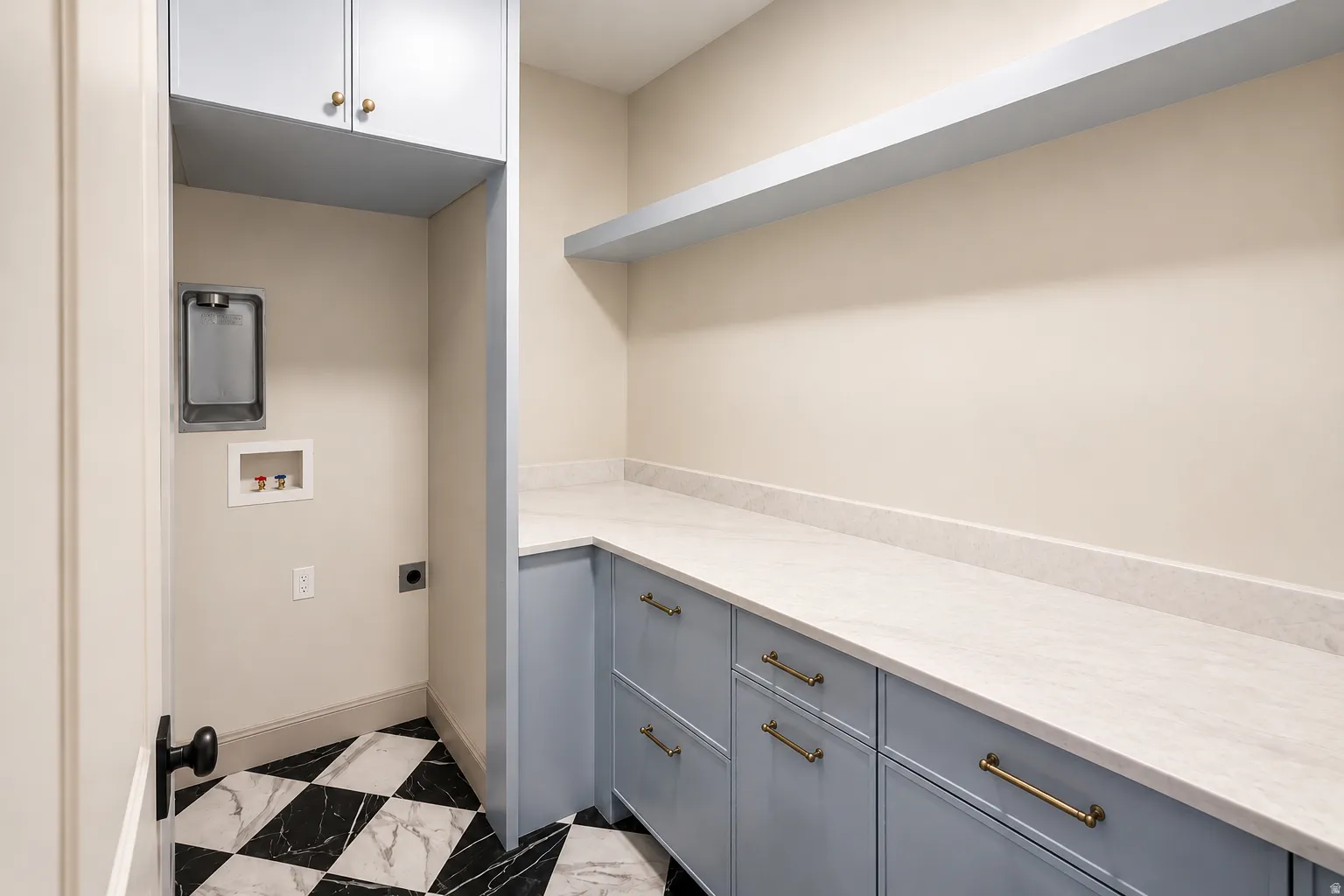 Brand new laundry space featuring built in cabinetry storage and fun checkerboard tile flooring.