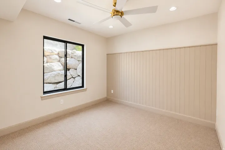 Bedroom 4 with lots of natural lighting, brand new carpet, windows, lighting, and accent wall.