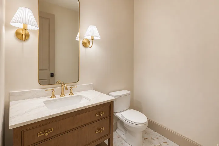 Warm powder bath with a new reeded wood vanity with herringbone tiled floors.