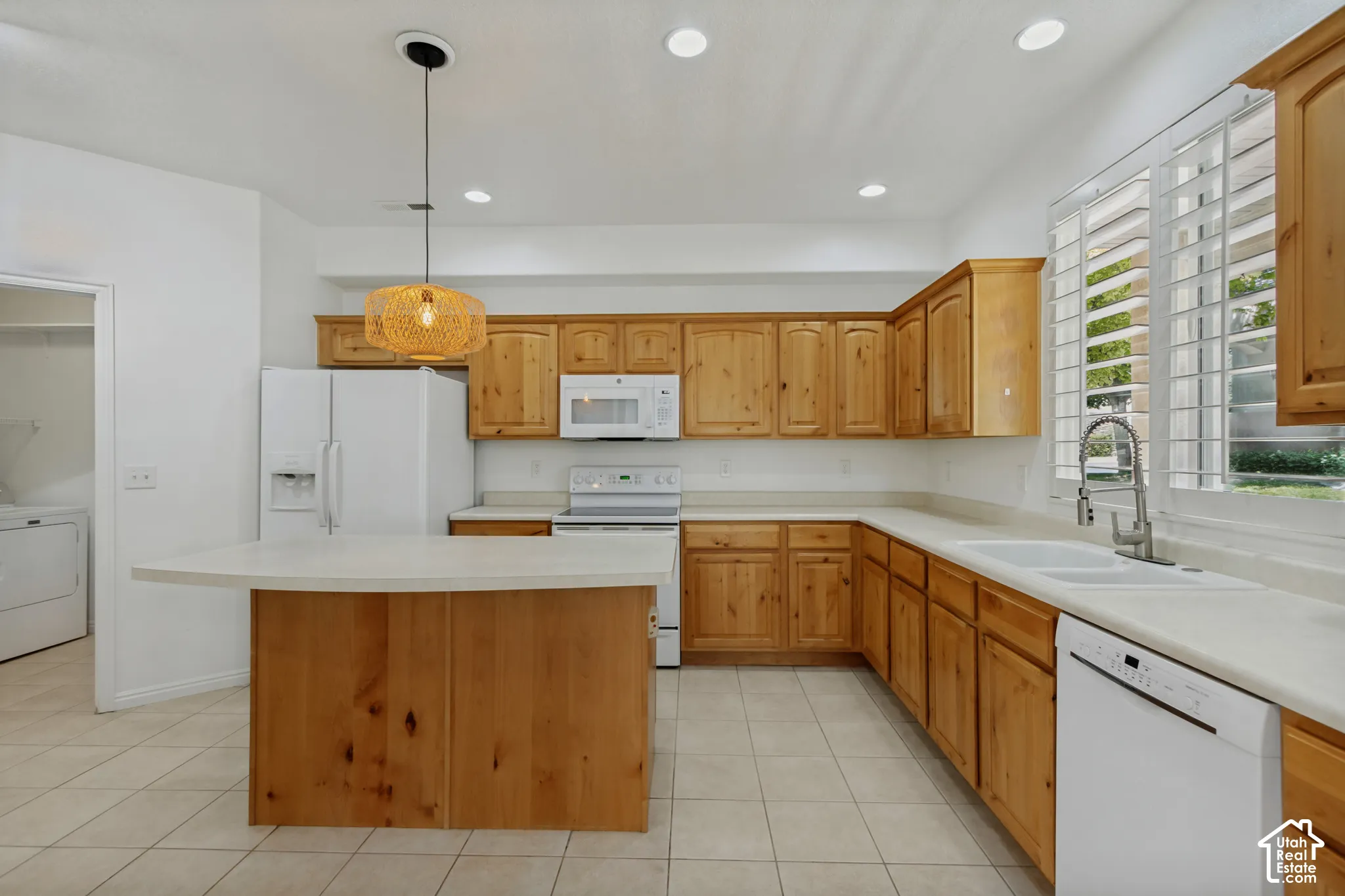 Kitchen featuring wood cabinetry, light countertops, and tile flooring