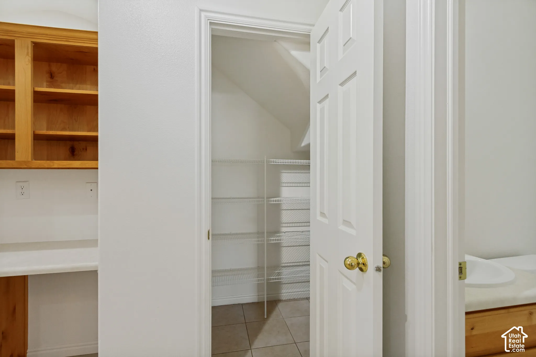 Built-in desk with wood-finish cabinetry, upper storage, and a solid surface countertop