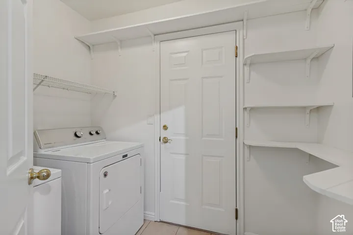 Utility area with white shelving units, wire rack storage, and a paneled door