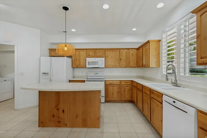 Kitchen featuring wood cabinetry, light countertops, and tile flooring